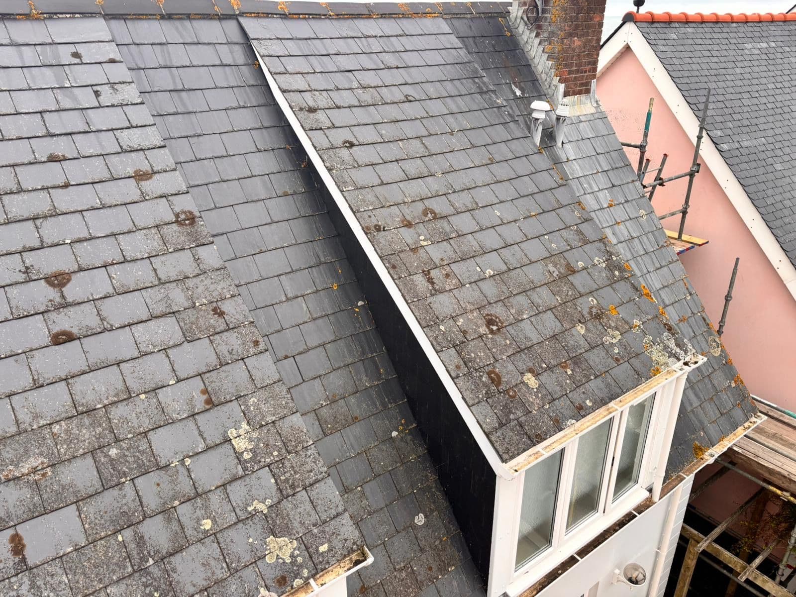 Before: slate roof with dormers, patched with lichen
